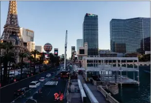  ?? PHOTOS BY MIKAYLA WHITMORE — THE NEW YORK TIMES ?? Workers block off Las Vegas Boulevard as they prepare to erect grandstand­s and viewing boxes in front of the Bellagio hotel's fountain for a Formula One street race in November.