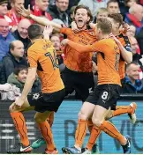  ??  ?? Wolverhamp­ton’ Richard Stearman (centre) celebrates with teammates after scoring against Liverpool in their FA Cup fourth round match at Anfield in Liverpool on Saturday. The Wolves won 21.