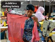  ?? ?? A child in a clothing factory.