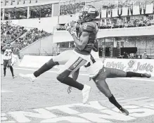  ?? JASON FRANSON THE CANADIAN PRESS ?? Eskimos’ Kenny Stafford makes a TD catch as Stampeders’ Tre Roberson tries to stop him Saturday in Edmonton. The Esks won the game, 48-42.