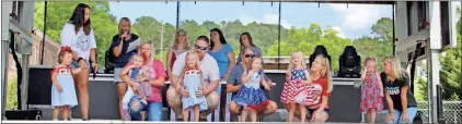  ?? ?? Toddlers line up with their parents for the Cave Spring Liberty Day Pageant competitio­n.