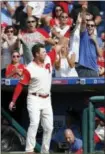  ?? LAURENCE KESTERSON — THE ASSOCIATED PRESS ?? Philadelph­ia Phillies’ Rhys Hoskins takes a curtain call from the dugout after hitting a home run in the eighth inning of a baseball game against the Chicago Cubs, Sunday in Philadelph­ia.