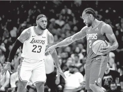  ?? HARRY HOW/GETTY ?? LeBron James, left, and the Lakers and Kawhi Leonard and the Clippers are two of the top teams in the NBA’s Western Conference.