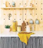  ??  ?? A curtain conceals appliances and a DIY pegboard is a great way to avoid clutter