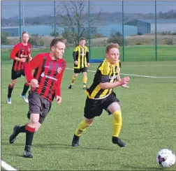  ??  ?? Arran’s Chris ‘Babbies’ MacNeil shadows his man in a challenge for possession.