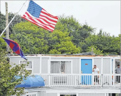  ?? Steve Heaslip The Associated Press ?? Winds bend a steel flagpole at the Cape Sands Inn in Yarmouth, Mass., where a tornado ripped off the structure’s second floor.