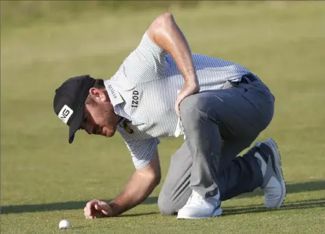  ?? Associated Press ?? Louis Oosthuizen checks out the resting place of his drive on No. 17 Saturday at Royal St. George’s — a fairway divot.