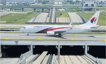  ?? BLOOMBERG ?? A Boeing 737 aircraft, operated by Malaysian Airlines, taxis at the Kuala Lumpur Internatio­nal Airport (KLIA) in Sepang on March 17.