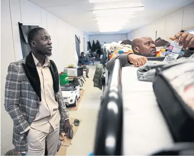  ?? R.J. JOHNSTON TORONTO STAR ?? Isaac Oppong, left, Miracle Arena’s shelter director, says the church is providing housing for newcomers who have no other options.