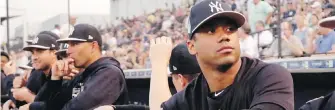  ?? LYNNE SLADKY, AP ?? Seattle Seahawks quarterbac­k Russell Wilson, right, watches from the dugout Monday as the New York Yankees played an exhibition game against the Philadelph­ia Phillies in Tampa, Florida.