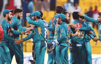  ?? Ahmed Kutty/Gulf News ?? Pakistan team celebrate after sneaking to a two-run victory in the first Twenty20 match against New Zealand at Zayed Cricket Stadium in Abu Dhabi on Wednesday.