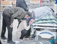  ?? AP PHOTO ?? Relatives weep over the body of an earthquake victim in Sarpol-e-Zahab, western Iran, Monday. Authoritie­s reported a powerful 7.3 magnitude earthquake struck the Iraq-Iran border region on Monday and killed more than 400 people in both countries.