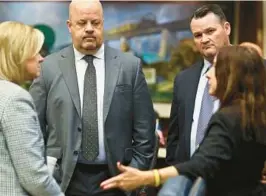  ?? PHIL SEARS/AP ?? Rep. Dana Trabulsy, R-Fort Pierce, Rep. Jeff Holcomb, R-Spring Hill, Rep. Brad Yeager, R-New Port Richey and Rep. Robin Bartleman, D-Weston, confer Monday at the Capitol in Tallahasse­e. Florida legislator­s are meeting in a two-week special session to take up a list of issues proposed by Gov. Ron DeSantis.