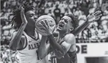  ?? THE ASSOCIATED PRESS ?? Oklahoma guard Trae Young, right, is fouled by Alabama guard Herbert Jones during the first half of Saturday’s game in Tuscaloosa, Ala. Alabama knocked off No. 12 Oklahoma 80-73.