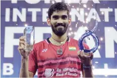  ?? — AFP ?? India’s Srikanth Kidambi poses with his trophy after winning the men’s singles final at the French Open badminton at the Coubertin Stadium in Paris.