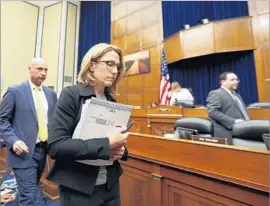  ?? Alex Brandon Associated Press ?? MYLAN CEO Heather Bresch, center, takes a break Wednesday as she testifies at the House Oversight Committee hearing on EpiPen price increases.