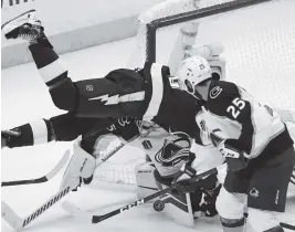  ?? JOHN BAZEMORE AP ?? Tampa Bay’s Corey Perry falls near the Avalanche net as goalie Darcy Kuemper blocks a shot. For Game 4 coverage, go to miamiheral­d.com/eedition/xtrasports.