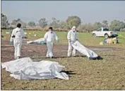  ?? Jorge Dan Lopez EPA/Shuttersto­ck ?? FORENSIC officials work after the explosion at an illegally tapped Pemex pipeline in Tlahuelilp­an.