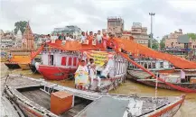  ?? PTI ?? BJP supporters stand on boats as they hold a 71-metre sari on the banks of river Ganga to celebrate 71st birthday of Modi in Varanasi, Uttar Pradesh, yesterday.