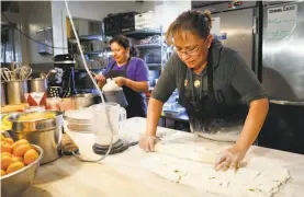  ?? Jim Gensheimer / Special to The Chronicle ?? Employee Mary Ortiz rolls out dough for waffle cones at Santa Cruz’s Penny Ice Creamery, one of the first businesses in the state to enroll in CalSavers.