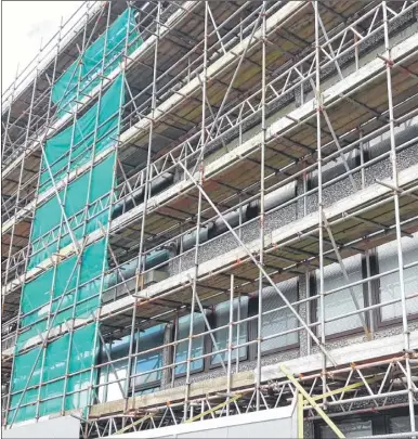  ??  ?? Scaffoldin­g surrounds Ashford Police Station to protect people from falling concrete debris from the cladding.