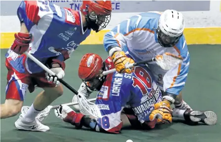 ?? CLIFFORD SKARSTEDT/ EXAMINER FILES ?? Peterborou­gh Century 21 Lakers' Zach Currier picks up a loose ball next to teammate Robert Hope pressured by Six Nations Chiefs' Craig Point during Major Series Lacrosse action on Aug. 24 at the Memorial Centre.