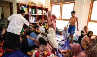  ?? AFP PHOTO ?? SURVIVORS
Rohingya refugees rest at the former Red Cross Indonesia office building in Meulaboh, West Aceh on Friday, March 22, 2024.