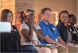  ?? TYGER WILLIAMS / MILWAUKEE JOURNAL SENTINEL ?? Arlene Mclaurin holds her hands up to her face as she watches a video about what is to come to work at the new Bucks arena. Mclaurin was enthusiast­ic throughout the whole training.