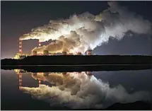  ?? CZAREK SOKOLOWSKI / AP FILE ?? Clouds of vapor drift over Europe’s largest lignite power plant in Belchatow, central Poland, in 2018.