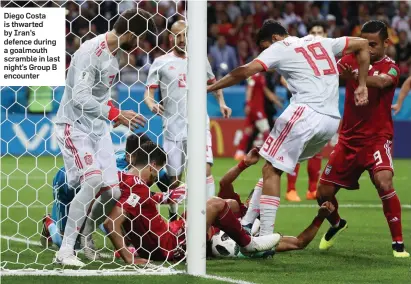  ??  ?? Diego Costa is thwarted by Iran’s defence during a goalmouth scramble in last night’s Group B encounter