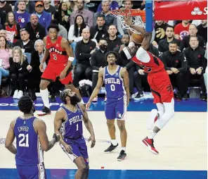  ?? STEVE RUSSELL TORONTO STAR ?? A trio of Philadelph­ia defenders watch as Toronto forward Chris Boucher dunks for two points, as the Raptors beat the 76ers 103-88 in Game 5 at Wells Fargo Center in Philadelph­ia on Monday.