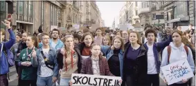  ?? AP ?? Activist Greta Thunberg, center, in a scene from the documentar­y "I Am Greta" the story of Thunberg, the teenage Swedish schoolgirl who is leading the global school strike for action on climate change.