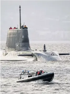  ?? ?? Submarine Astute is escorted to its home base at Faslane, on Gare Loch
Picture Danny Lawson