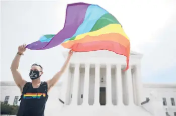  ?? CHIP SOMODEVILL­A/GETTY 2020 ?? A person in Washington, D.C., celebrates a Supreme Court ruling involving LGBTQ rights.