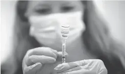  ?? Tribune News Serviceget­ty Images ?? Safeway pharmacist Ashley Mcgee fills a syringe with the Pfizer COVID-19 booster vaccinatio­n at a vaccinatio­n booster shot clinic on Oct. 1 in San Rafael.