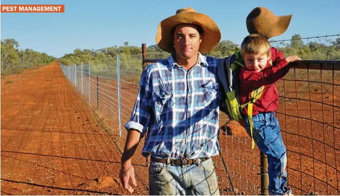  ?? PHOTO: CONTRIBUTE­D ?? STEPPING UP: Wool producer Donald Truss from Toompine, south of Quilpie, with his son Henry and a stretch of the wild dog exclusion fencing on his property.