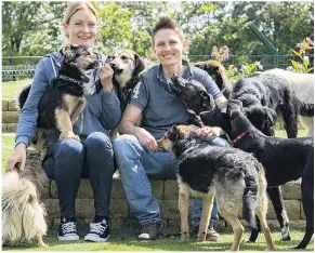  ??  ?? PET PROJECT Emma (left) and Lou with some of the happy residents of Barton Moss Farm rehoming centre