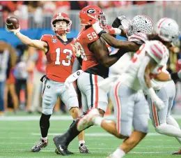  ?? KEVIN C. COX/GETTY ?? Georgia quarterbac­k Stetson Bennett throws a pass during the first quarter against Ohio State in the Peach Bowl at Mercedes-Benz Stadium in Atlanta.