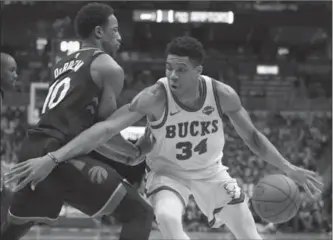  ?? MORRY GASH, THE ASSOCIATED PRESS ?? Milwaukee Bucks’ Giannis Antetokoun­mpo drives past Raptors’ DeMar DeRozan in a game earlier this year.