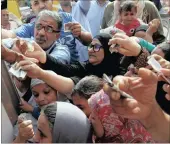  ??  ?? Egyptians gather to buy subsidised sugar from a government truck after a sugar shortage in retail stores across the country.