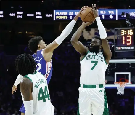  ?? GETTy imAgES ?? TOUGH NIGHT: Philadelph­ia’s Matisse Thybulle blocks Jaylen Brown during the first quarter at Wells Fargo Center on Friday night in Philadelph­ia, Pa.