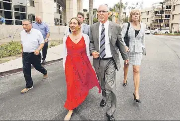  ?? Al Seib Los Angeles Times ?? DR. JAMES HEAPS, a former UCLA gynecologi­st, with wife Deborah Heaps, left, and attorney Tracy Green after a court hearing. The doctor has pleaded not guilty to charges of sexual battery and exploitati­on.