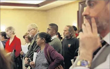  ?? Katie Falkenberg Los Angeles Times ?? PORTER RANCH residents listen during a meeting held in December by two law groups discussing potential compensati­on from Southern California Gas Co. for people affected by the natural gas leak in Aliso Canyon.