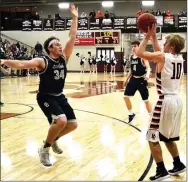  ?? TIMES photograph by Annette Beard ?? Junior Blackhawk Carson Rhine (No. 10) scored 3 points in the Friday night contest against Shiloh during the District Tournament in Lincoln.