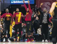  ?? JASON MILLER/GETTY IMAGES ?? LeBron James, middle, and the Cleveland Cavaliers celebrate early Monday on their way to eliminatin­g the Raptors.