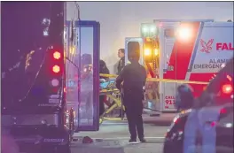  ?? DYLAN BOUSCHER — STAFF ARCHIVES ?? Paramedics and police officers respond to gunfire aimed at a party bus that left two people dead and six others wounded in Oakland on May 18.