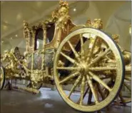  ?? RICHARD LEWIS — THE ASSOCIATED PRESS FILE ?? This file photo, shows the Queen’s Gold State Coach in the Royal Mews in Buckingham Palace, in London,