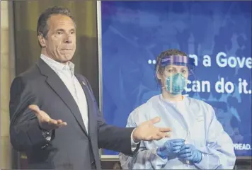  ?? Angus mordant / Bloomberg ?? Gov. Andrew Cuomo received a nasal swab Covid-19 test during a may 17 news conference in the red room of the state Capitol in Albany. Cuomo is pleading for more new Yorkers to get tested as new York reopens for business.