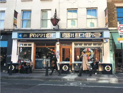  ?? PHOTOS BY WILL HAWKES FOR THE WASHINGTON POST ?? ABOVE: Poppie’s is a popular restaurant in Spitalfiel­ds, London. One of the city’s newer chippies, it’s part of a small chain, which is unusual. Most such eateries are independen­t. TOP LEFT: A plate of cod and chips, plus side portions of mushy peas and tartar sauce, at Olley’s, a fish-and-chips restaurant in Herne Hill, South London, is sure to satisfy. BOTTOM LEFT: The office of the defunct Mann, Crossman and Paulin brewery in Whitechape­l in London’s East End is a point of interest for tourists.