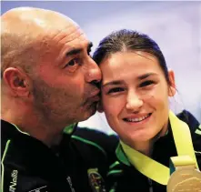  ??  ?? Pete Taylor congratula­tes his Olympic champion daughter, boxer Katie Taylor. Below, a message by shooting survivor Ian Britton in the back of an ambulance